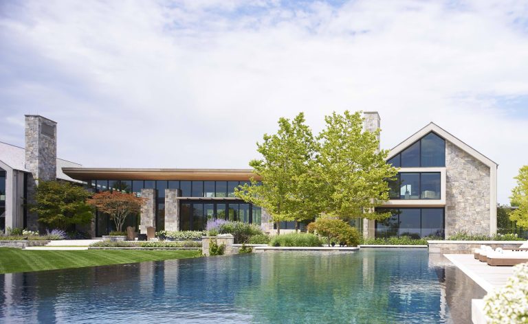 Pool - huge modern backyard custom-shaped infinity pool idea in New York