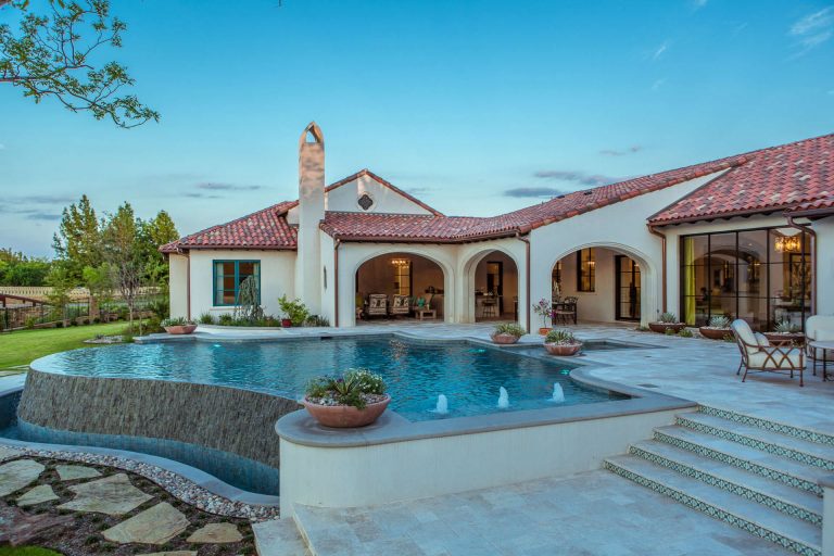 Pool - huge southwestern backyard stone and custom-shaped infinity pool idea in Dallas