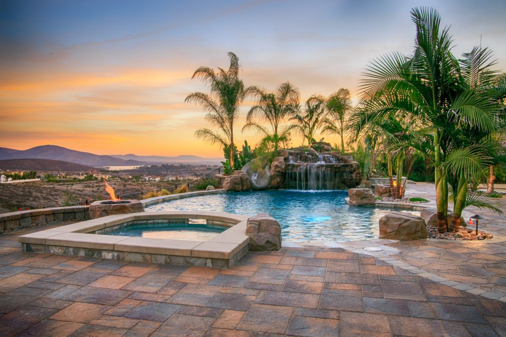 Pool - huge traditional backyard concrete paver pool idea in San Diego