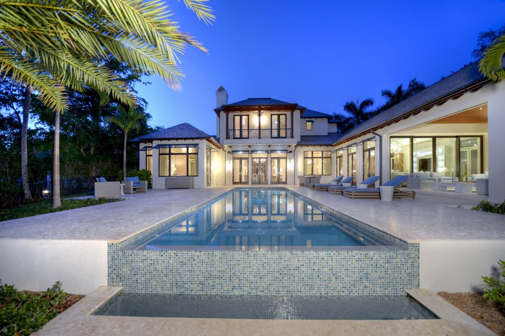 Pool - huge tropical backyard tile and rectangular infinity pool idea in Cleveland