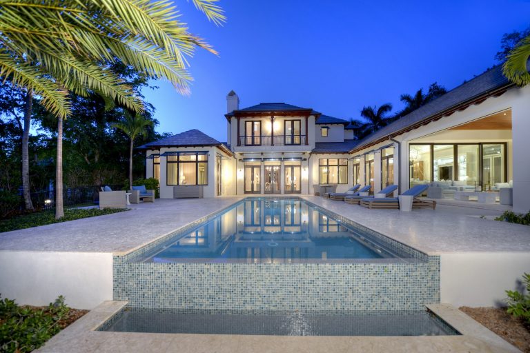 Pool - huge tropical backyard tile and rectangular infinity pool idea in Cleveland