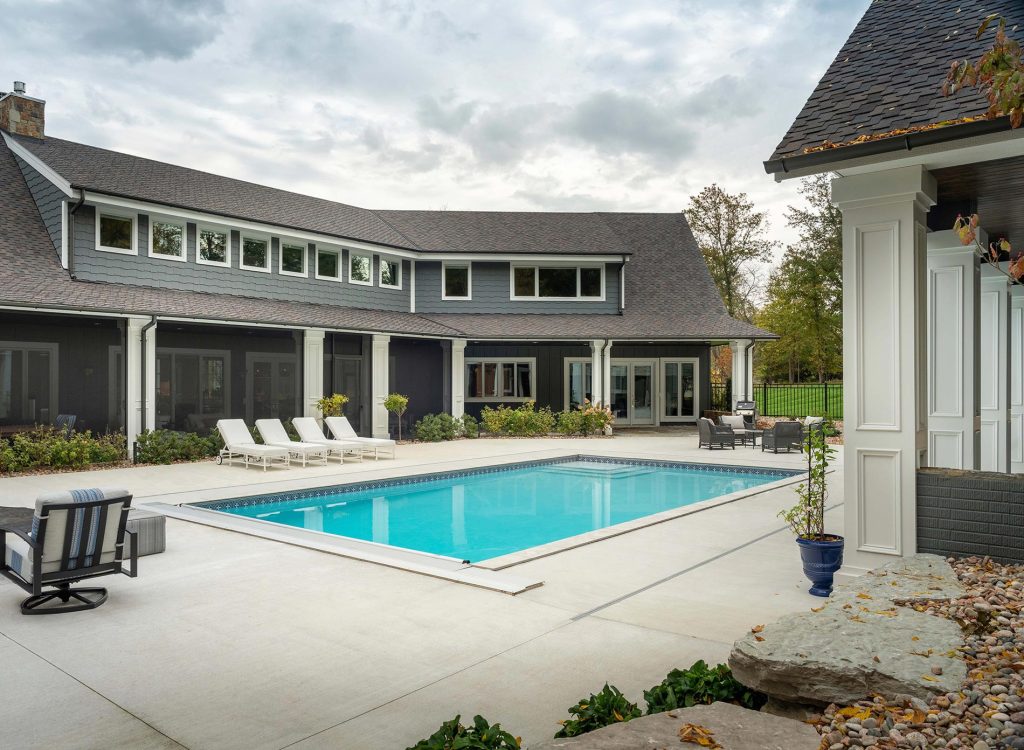 Pool landscaping - huge traditional backyard concrete and rectangular pool landscaping idea in Other