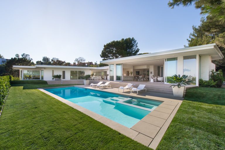 Pool - large 1960s backyard concrete and rectangular pool idea in Los Angeles