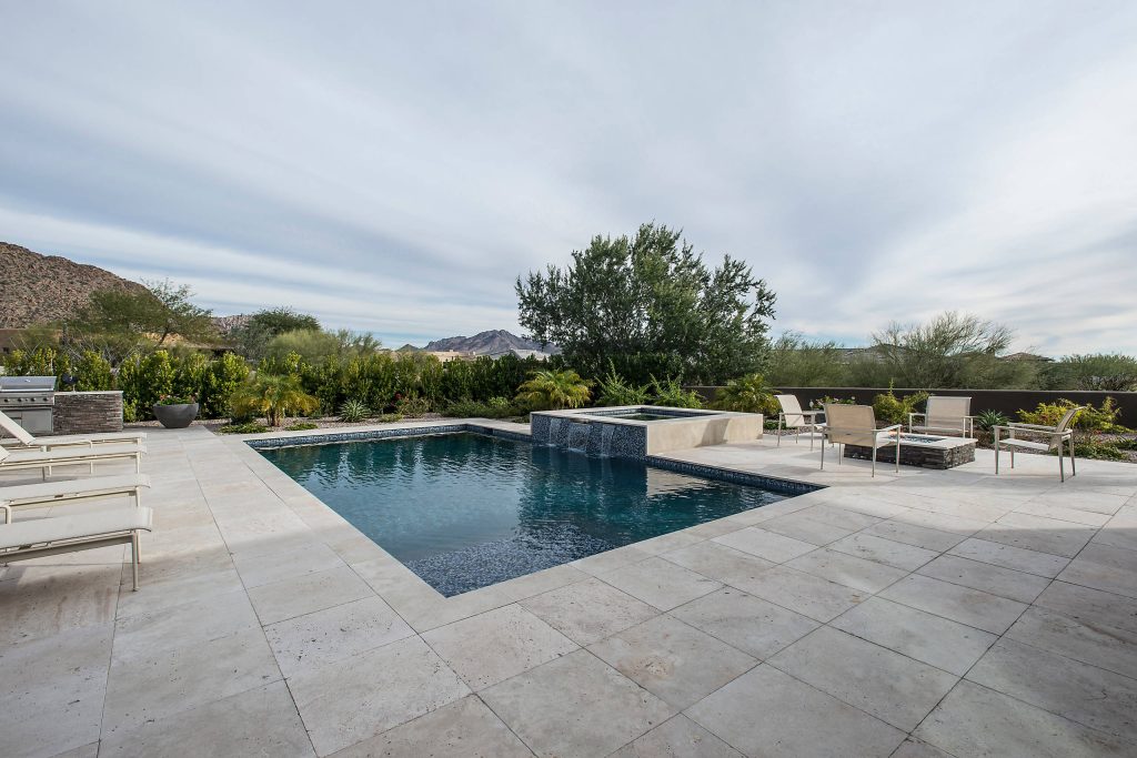 Pool - large contemporary backyard stone and rectangular pool idea in Phoenix