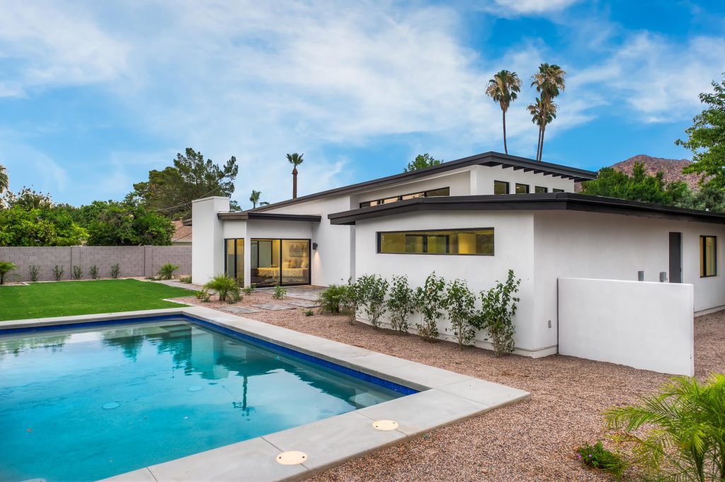 Pool - large modern backyard stone and rectangular lap pool idea in Phoenix