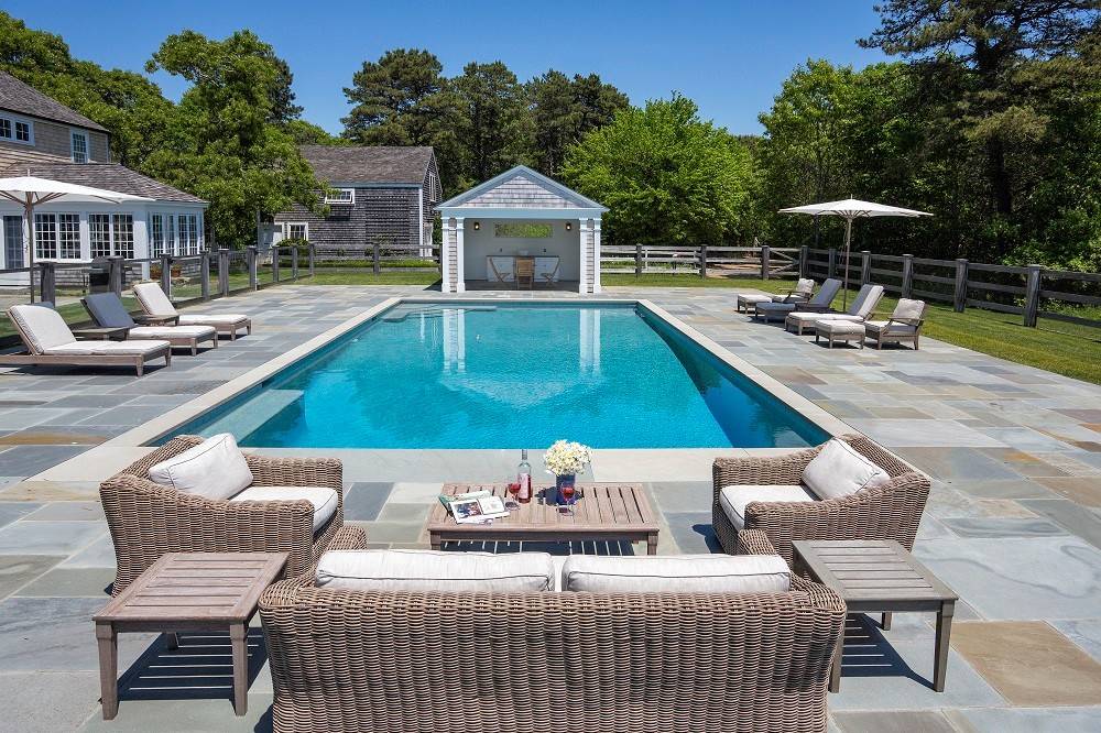 Pool - large traditional backyard rectangular and concrete paver lap pool idea in Boston