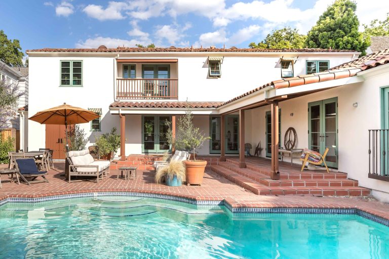 Pool - mediterranean backyard brick and custom-shaped pool idea in Sacramento