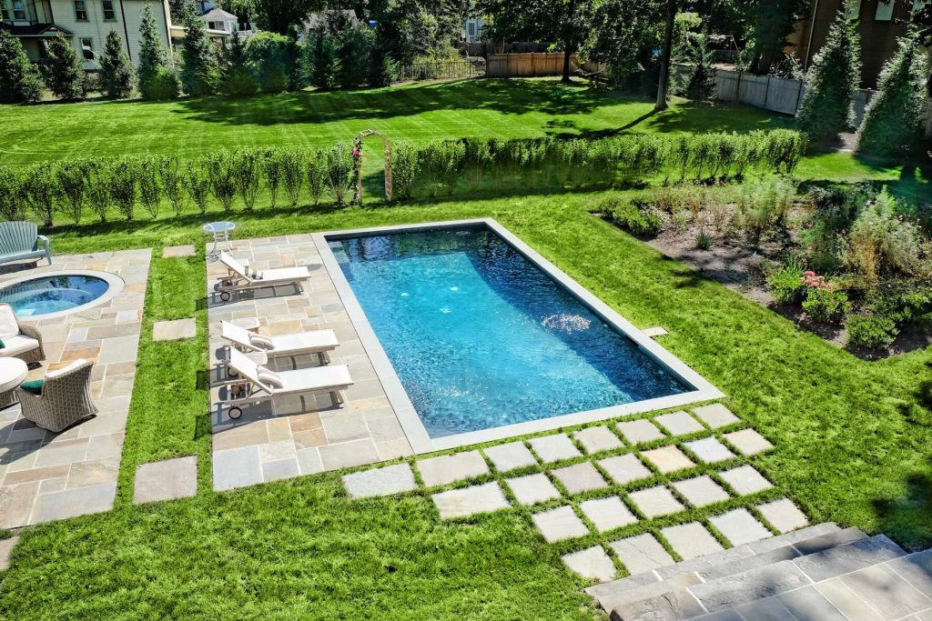 Pool - mid-sized farmhouse backyard tile and rectangular lap pool idea in Bridgeport