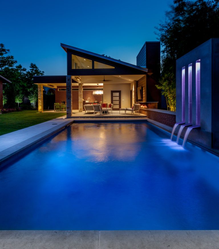 Pool - mid-sized modern backyard pool idea in Dallas with decking