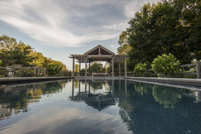 Pool - mid-sized traditional backyard stone and rectangular lap pool idea in New York