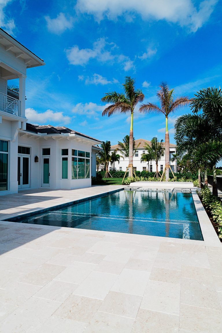 Pool - mid-sized tropical backyard stone pool idea in Miami