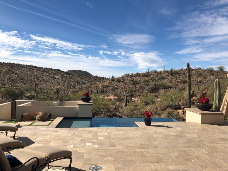 Pool - small contemporary backyard stone and custom-shaped infinity pool idea in Phoenix