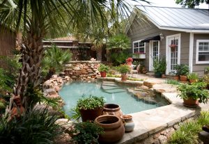 Pool - small rustic backyard stone and custom-shaped natural pool idea in Austin