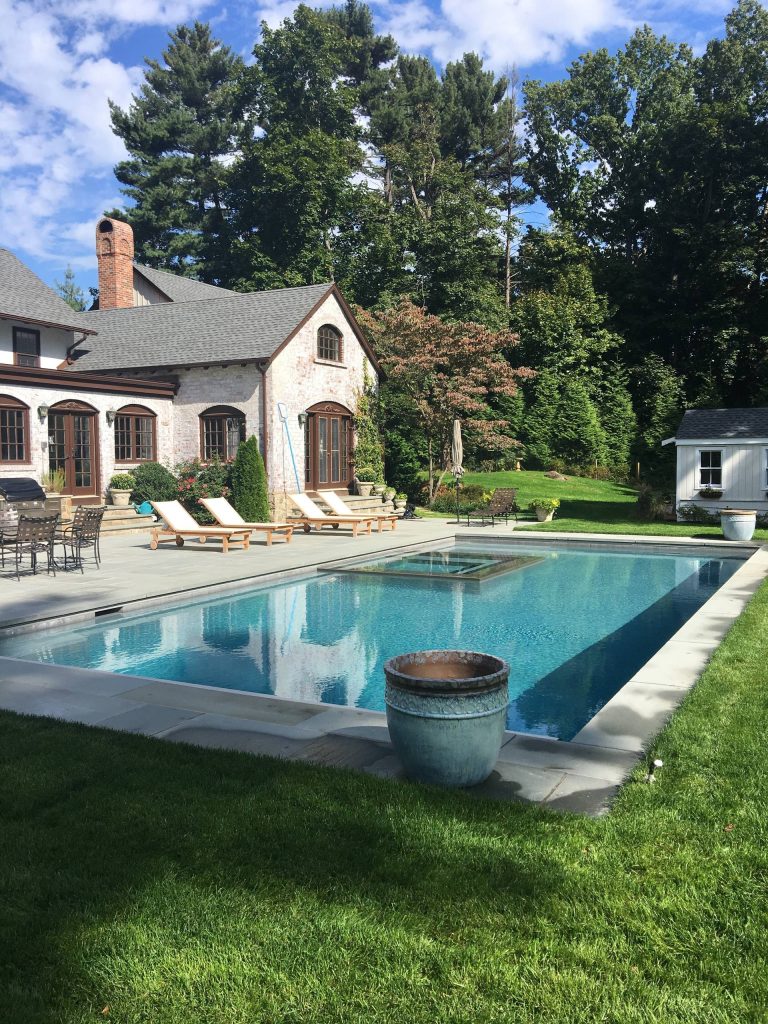 Pool & spa with a sunshelf surrounded by bluestone patio.