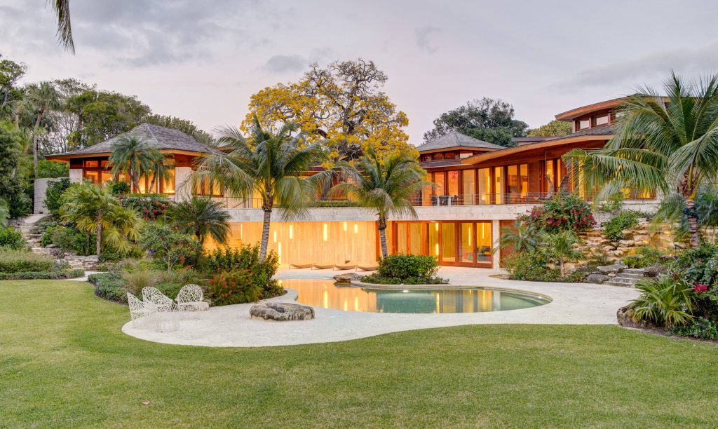 Pool - tropical backyard custom-shaped lap pool idea in Los Angeles
