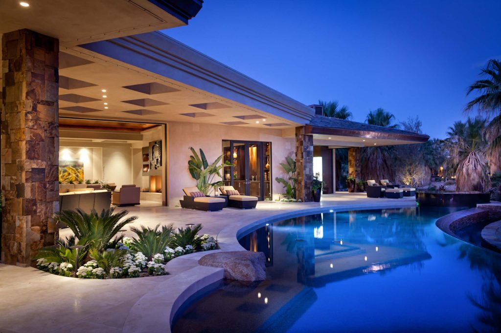 Pool - tropical backyard custom-shaped pool idea in San Diego