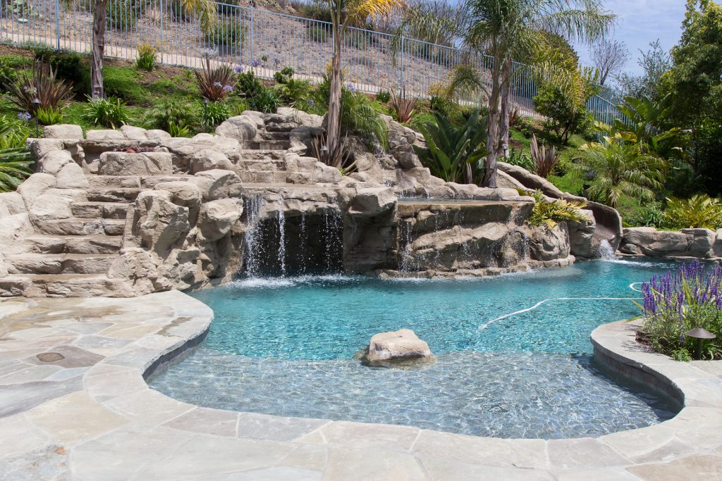 Pool with rock slide and jacuzzi Photos By: Jannus Studios