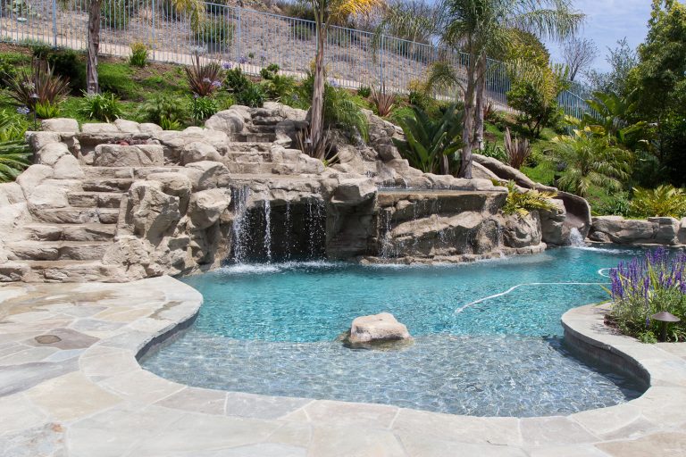Pool with rock slide and jacuzzi Photos By: Jannus Studios