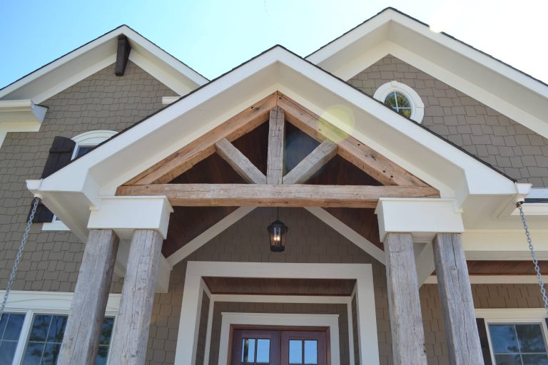 Porch open gable truss detail made out of antique hand-hewn barn beams, with stained fir T & G cathedral ceiling. by Hearth & Stone Builders