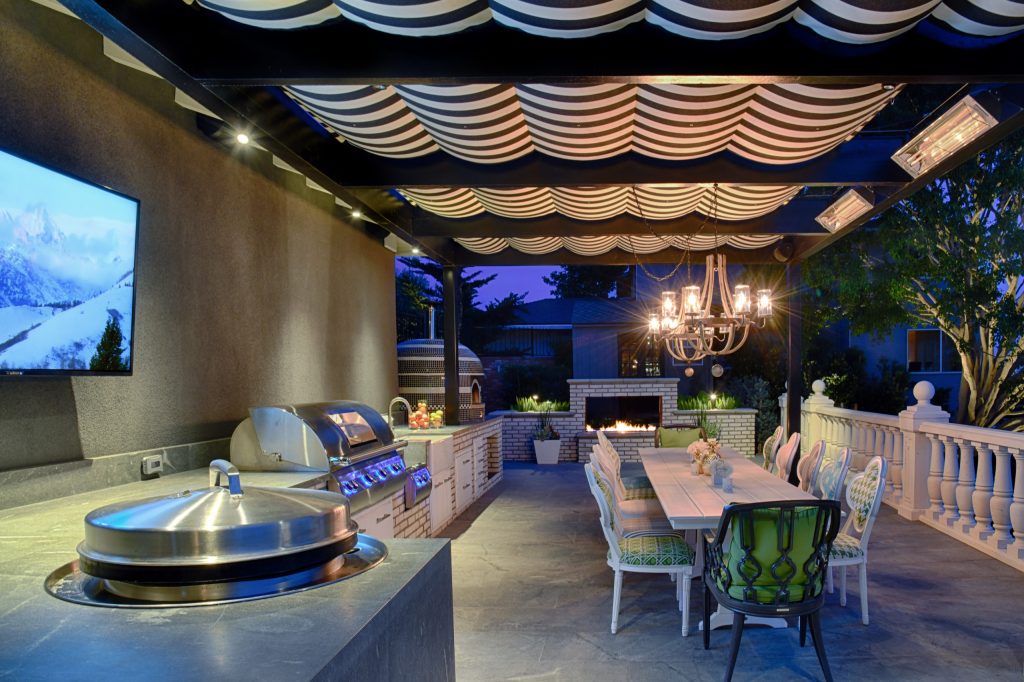 Post-war modern outdoor kitchen in Mission Hills. Two-sided fireplace, pizza oven, BBQ, pergola with shade canvas
