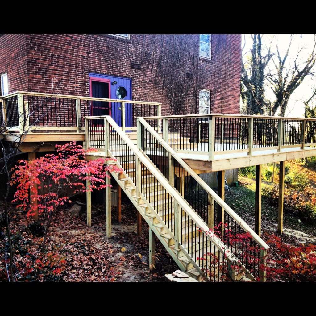 Pressure treated multi level rear deck. Utilizes Trex Black Aluminum Balusters for a clean, modern look - Brad Arkill