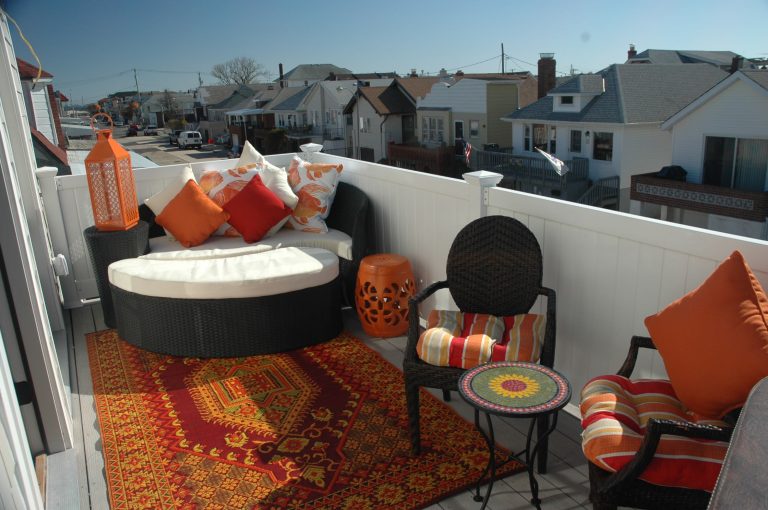 Private "getaway" patio off of the master bedroom. This bright and cozy porch overlooks the bay and has a hot tub.