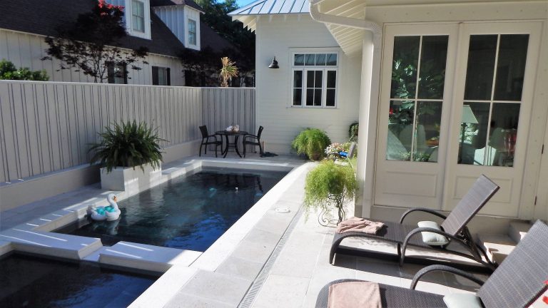 Private pool and patio area nestled in back yard. Photo by Tom Aiken