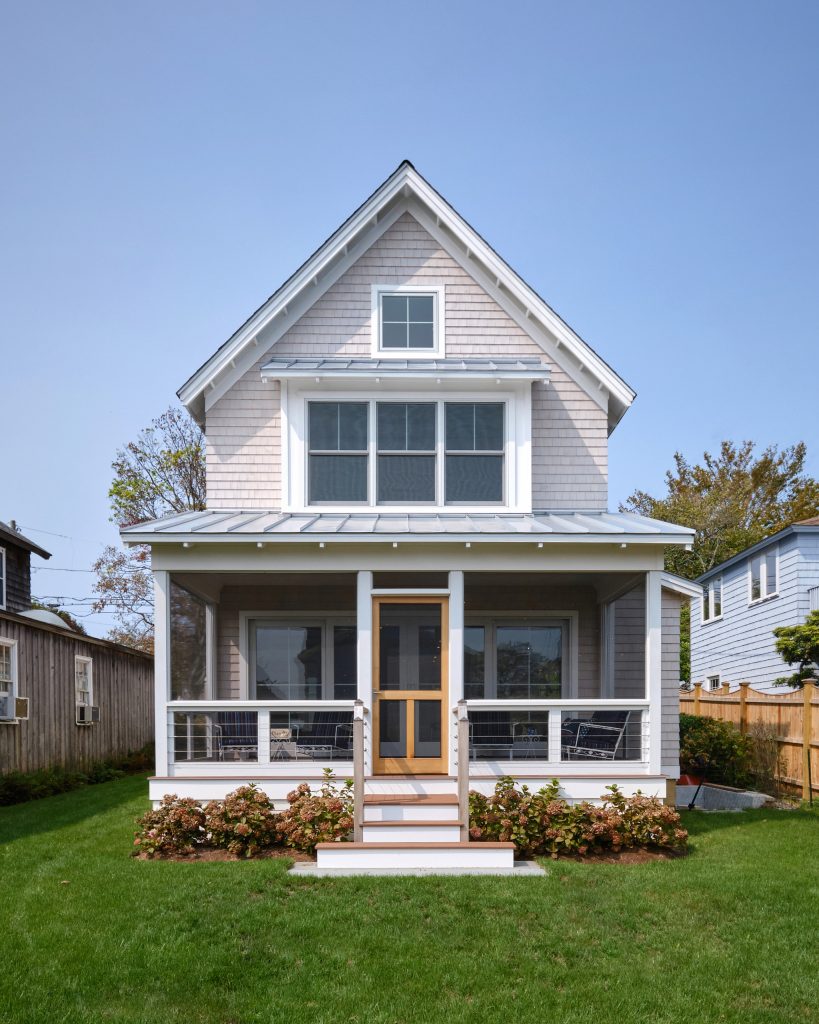 Providing an exit to the south end of the home is a screened-in porch that runs the entire width of the home and provides wonderful views of the shoreline. Dennis M. Carbo Photography by Joseph Sepot Architects | Outdoor Photos | Porch | Landscaping | Landscape Design | Outdoor Living Space | Porch Design Ideas | Outdoor Living Space Ideas | Backyard Design