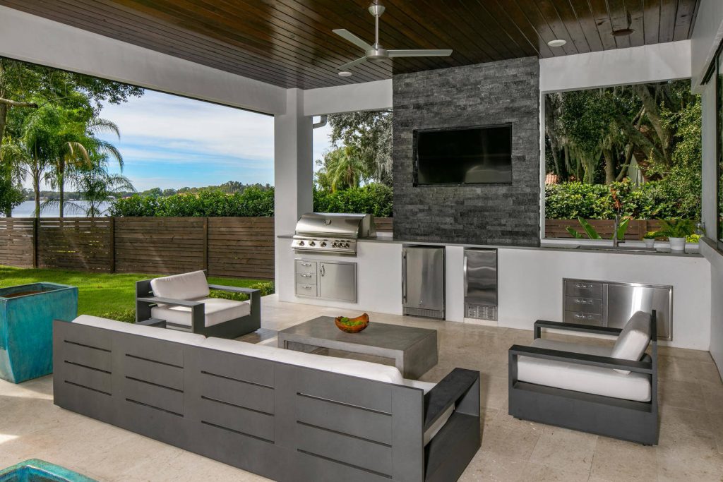 REAR LOGGIA WITH BUILT IN KITCHEN, FIREPLACE, AND MODERN FURNISHINGS, FIXTURES AND FINISHES.