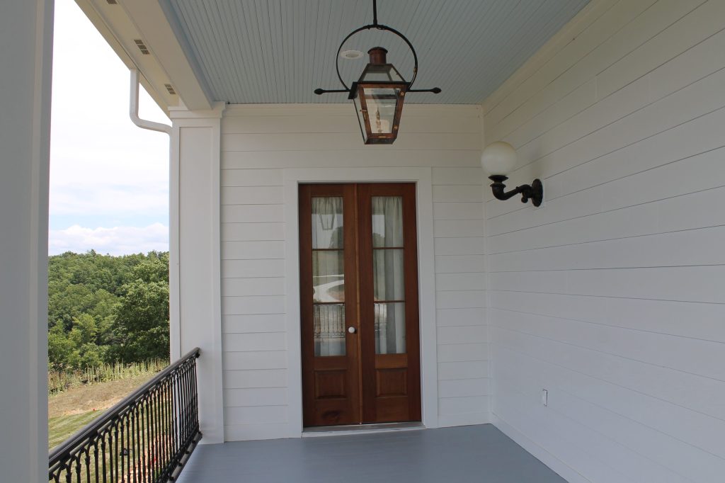 Real Gas Lanterns, Iron Railings, Wood-Glass Doors with Porcelain Knobs reinforces the French Acadian Styling.