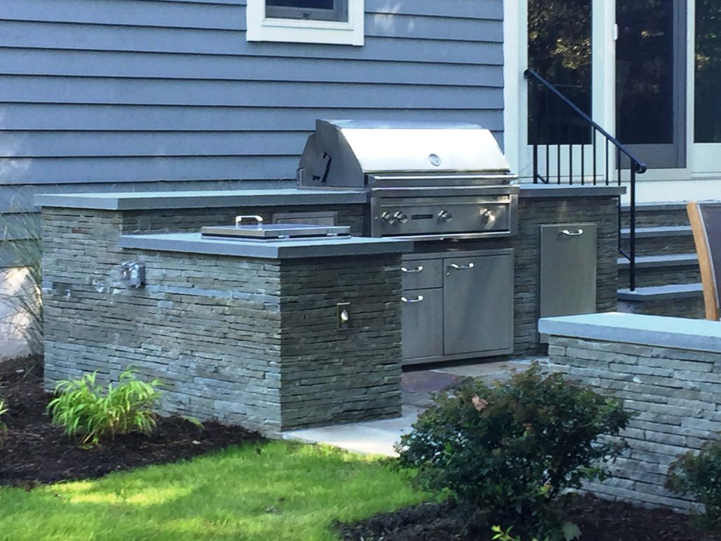 Rear terrace area including fire pit, BBQ area, seat walls and landscape