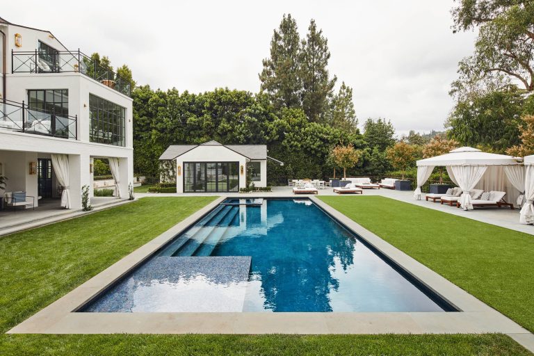 Rear yard with pool and pool house of a now Classical Contemporary residence in Los Angeles, CA.
