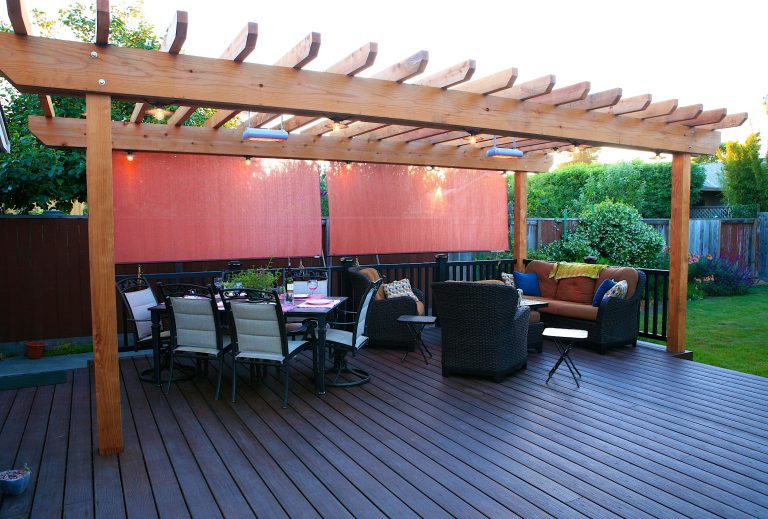 Redwood trellis, trex decking and railing, and custom lighting make this a stunning space.