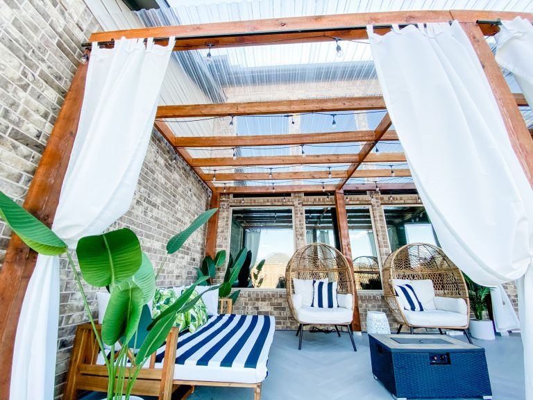 Relaxing tropical patio extension with custom upholstery and herringbone style floor tiles
