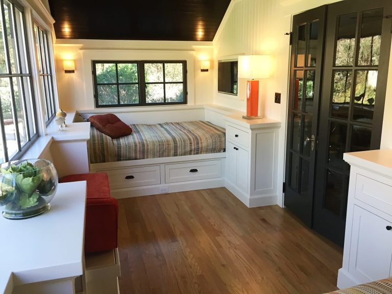 Remodeled sleeping porch with built in beds and storage.