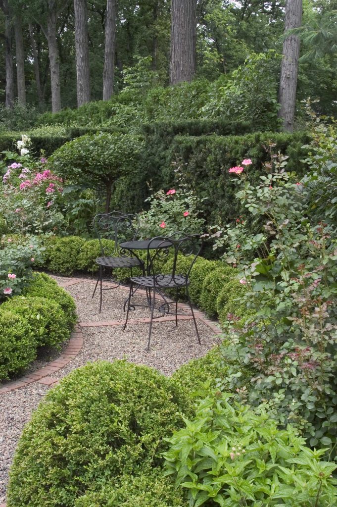 Request Free Quote Plant bed ideas with garden path and cafe table and chairs in Winnetka, IL. by Schmechtig Landscapes