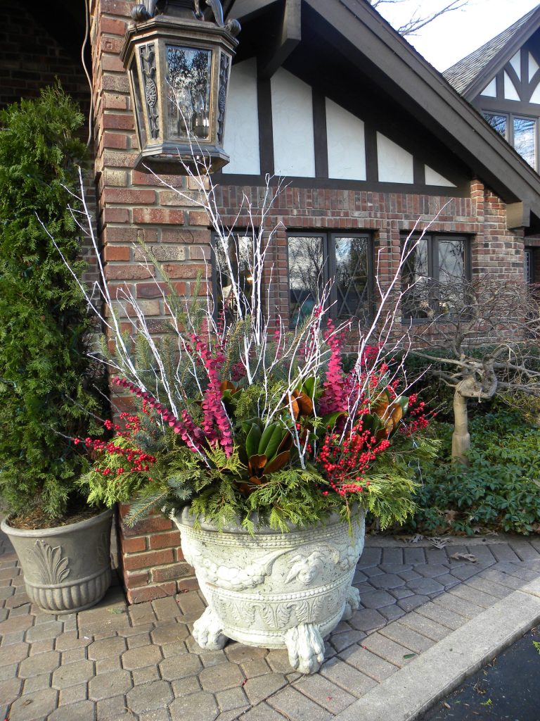 Residential Landscape Containers. What a way to welcome your holiday guests. A beautiful winter container to add to your front porch. Classic porch idea in Chicago by Smalls Landscaping | Outdoor Photos | Porch | Landscaping | Landscape Design | Outdoor Living Space | Porch Design Ideas | Outdoor Living Space Ideas | Backyard Design