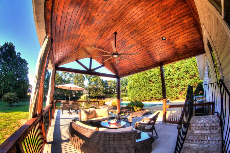 Roof cover with open gable roof line and stained tongue and groove ceiling.