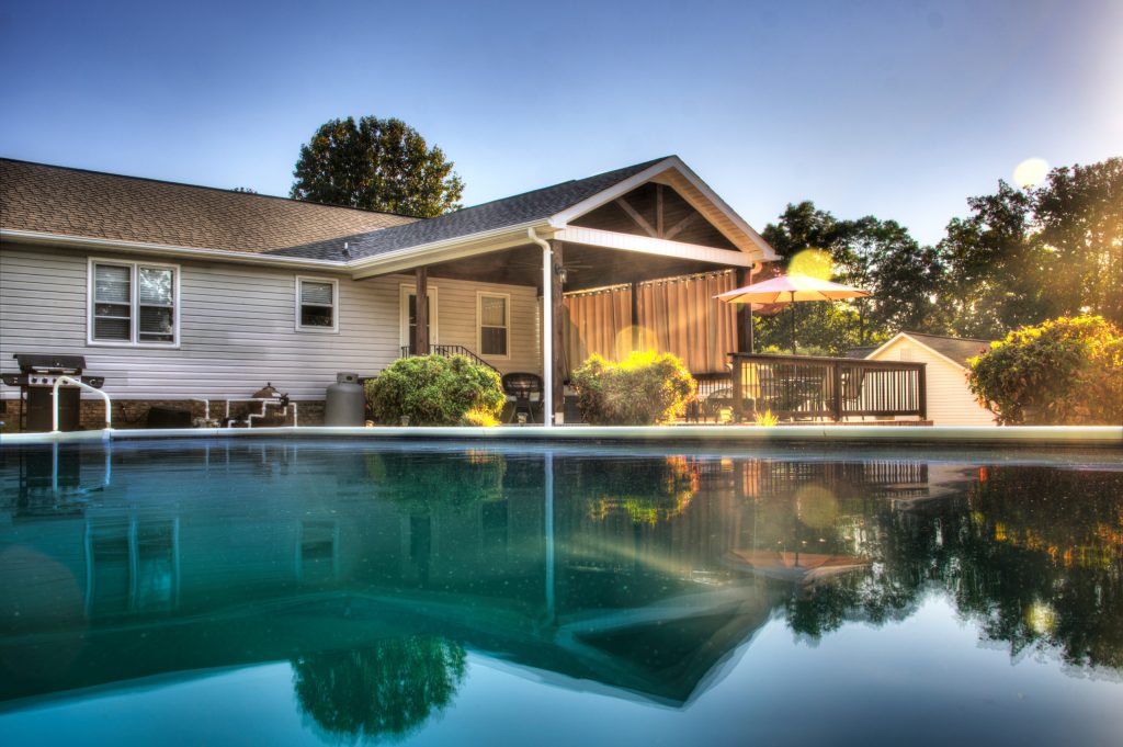 Roof cover with open gable roof line and stained tongue and groove ceiling.