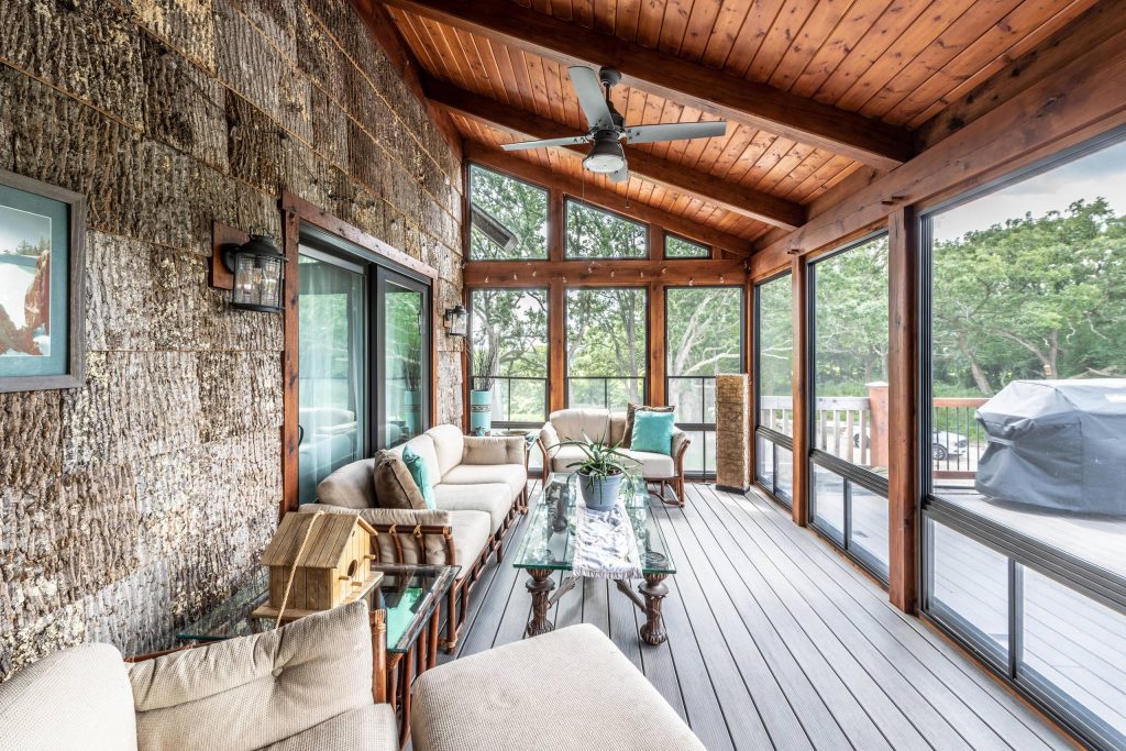 Rustic screen porch with bark clad siding and oak timbers and timber tech decking