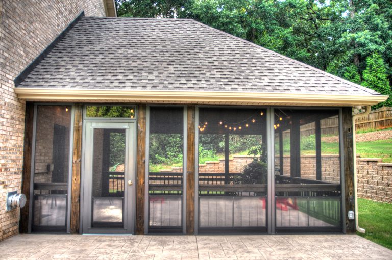 Screen porch with stained open beam ceiling and stamped concrete flooring. Outdoor patio is also stamped concrete with a fire pit and block retaining walls. by Nexgen Contractors LLC | Outdoor Photos | Porch | Landscaping | Landscape Design | Outdoor Living Space | Porch Design Ideas | Outdoor Living Space Ideas | Backyard Design