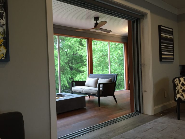 Screened covered deck. Ipe Shiplap siding. Sliding pocket door by Panda Windows and Doors.