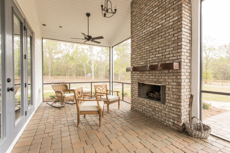 Screened in back porch with brick fireplace. The Kinsley model built by Bennett Construction.
