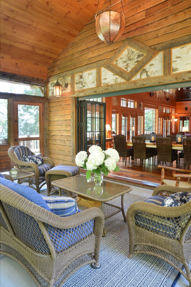Screened in porch for all seasons, with folding doors that open to the living area all summer long. Blue and white fabrics highlight the birch bark accents.