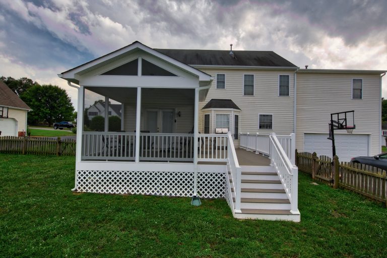 Screened in/open porch hybrid with custom railing and stairs leading to lawn