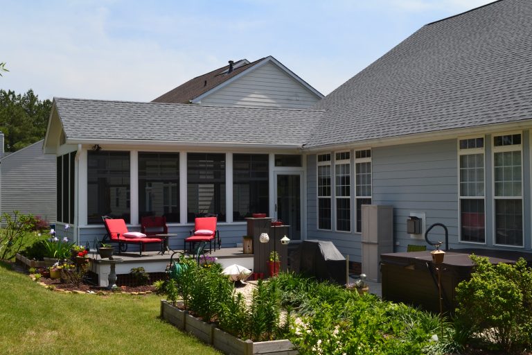 Screened porch addition with Timbertech composite decking, Eze-Breeze windows, and PVC columns.