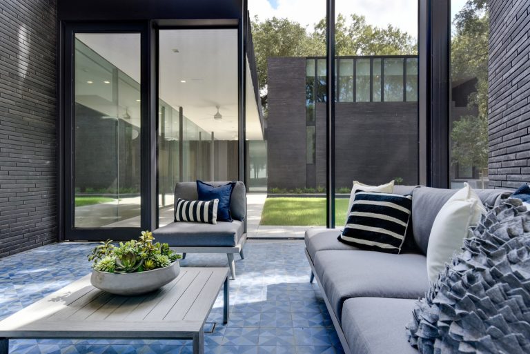 Screened porch with 2 story wall and mid-century inspired tile floor.