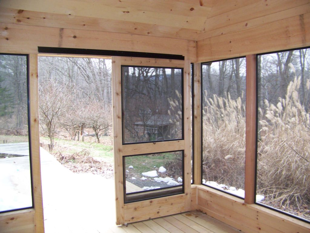 Screened porch with sliding doors and minitrack screening system.