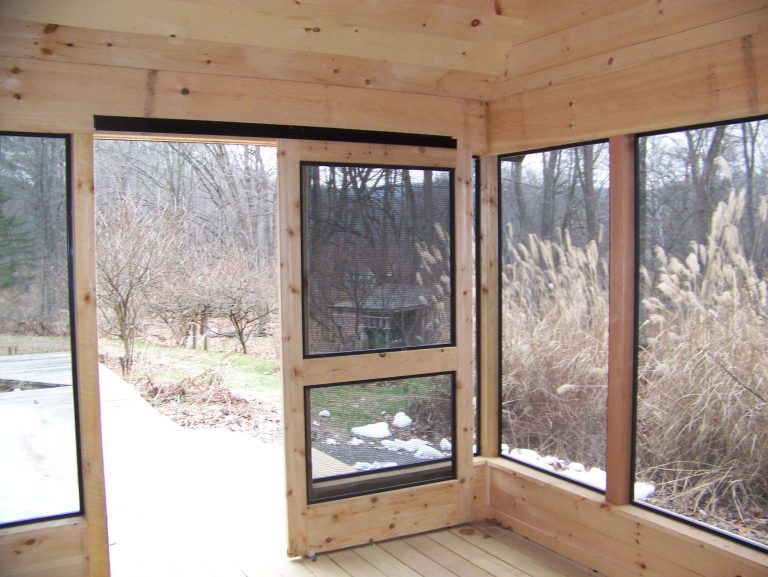 Screened porch with sliding doors and minitrack screening system.