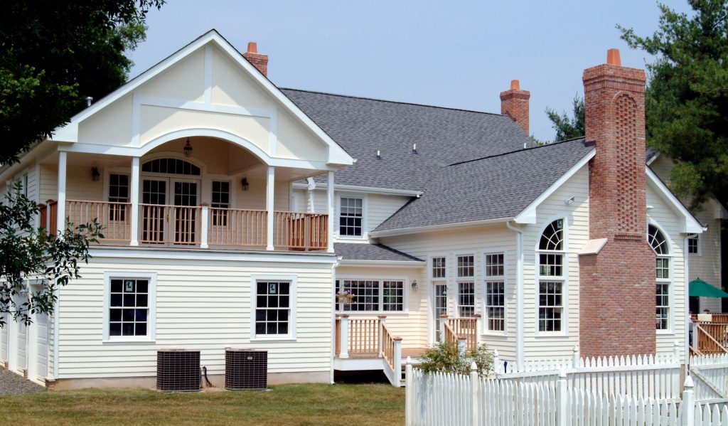 Second floor deck created over garage with connecting first floor deck in between space on first floor.